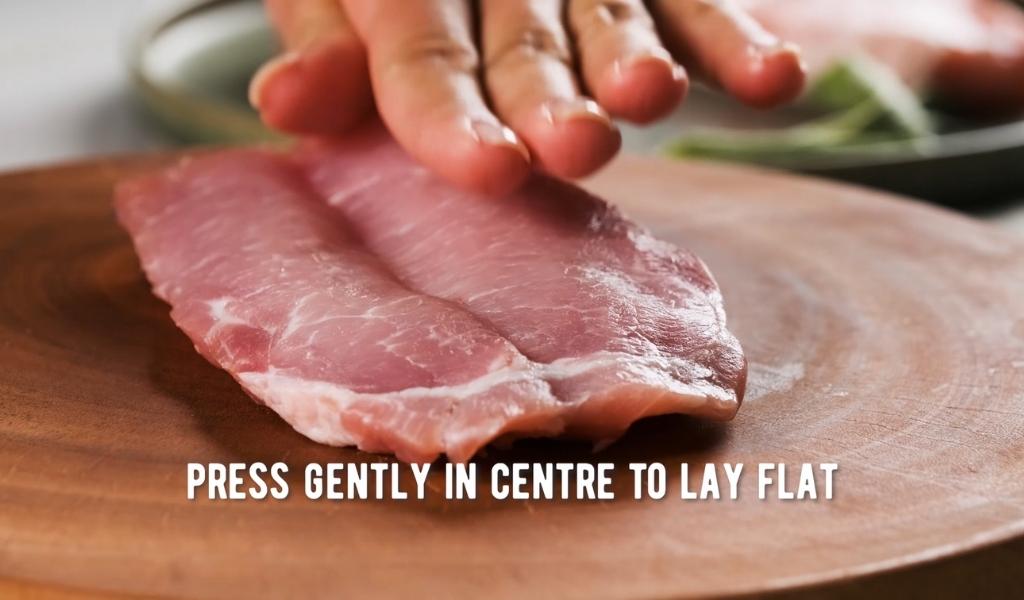 Step 4 to butterflying a pork chop - press down gently Step 4 to butterflying a pork chop - press down gently